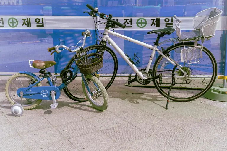 black and blue city bike parked beside blue wall